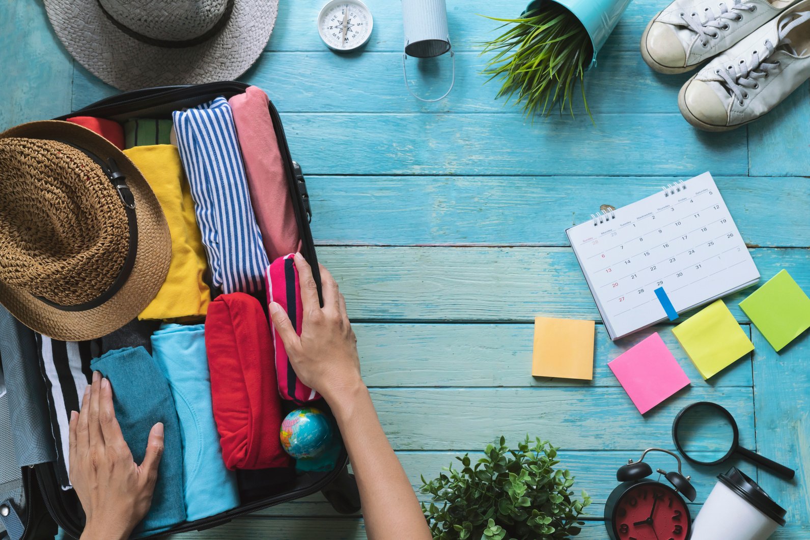 woman hands packing a luggage for a new journey and travel for a long weekend